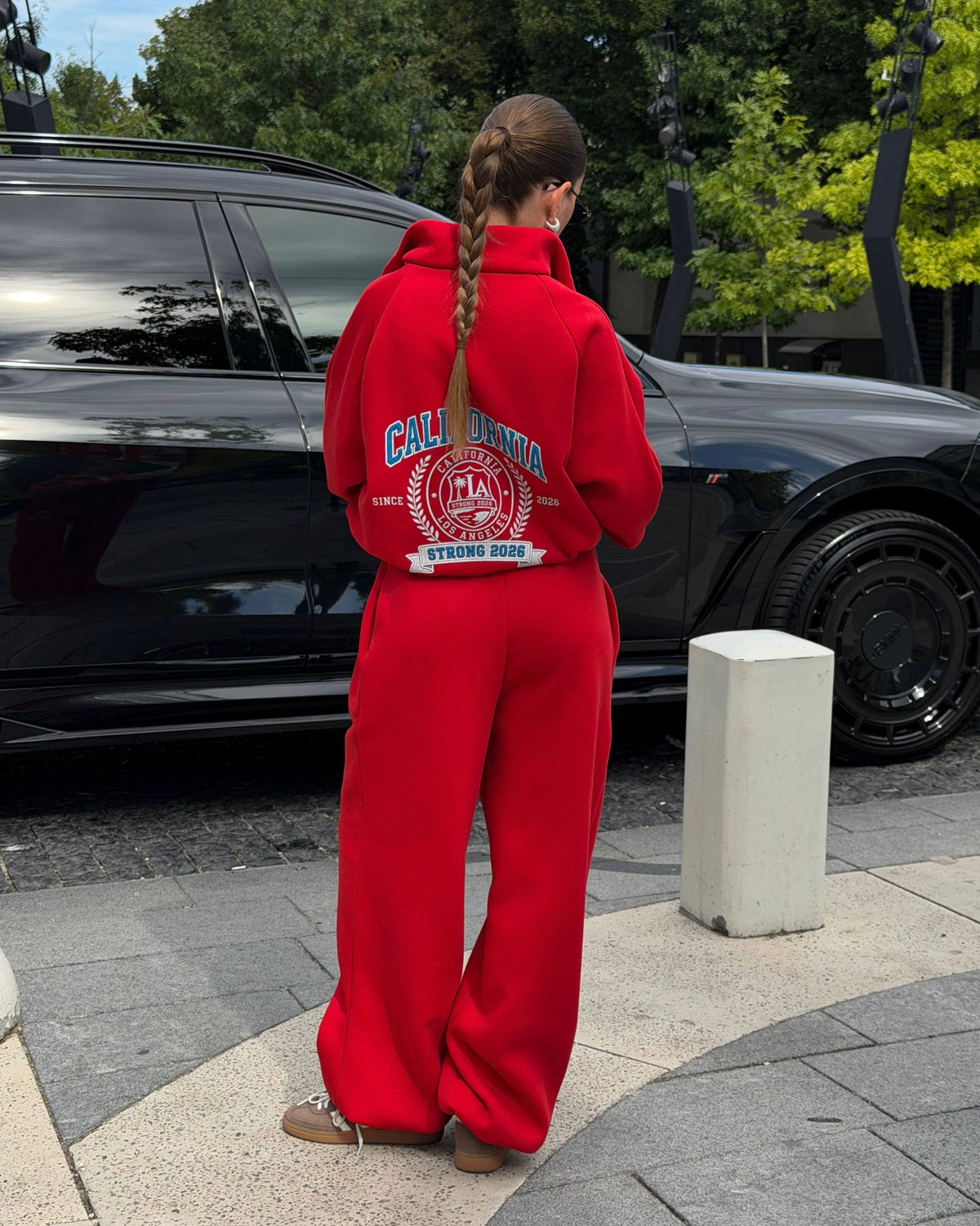 Red oversized tracksuit - back view with large crest print and wide-leg trousers