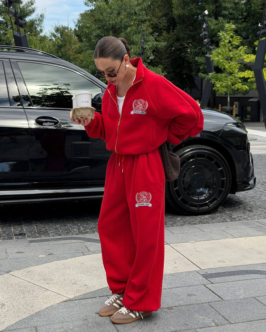 Red oversized zip jacket and wide-leg trousers with crest print - full-length look