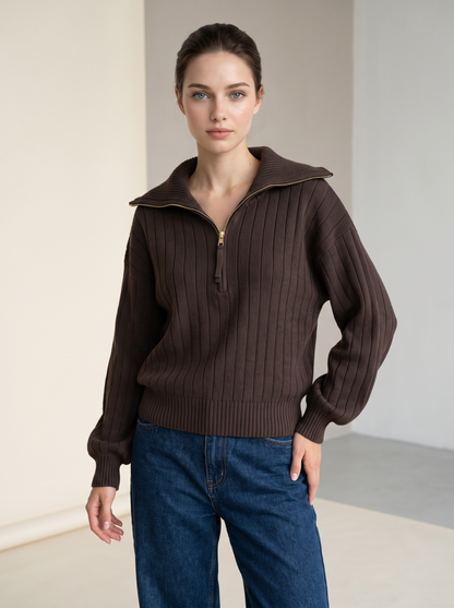 Woman wearing chocolate brown ribbed knit half-zip sweatshirt, front view with jeans