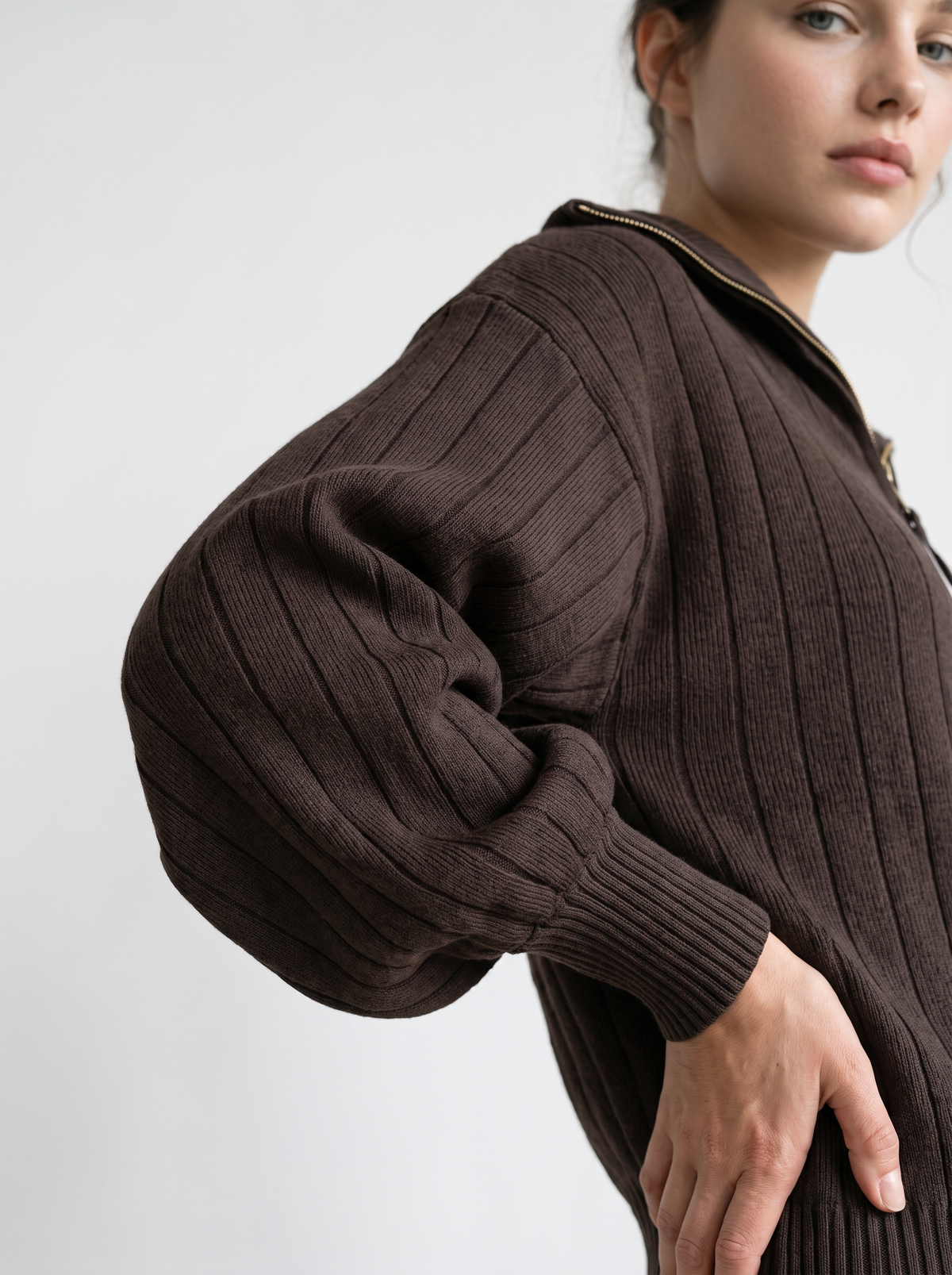 Detail of chocolate brown ribbed knit sweatshirt sleeve