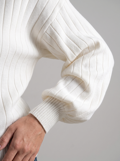Woman wearing cream ribbed knit half-zip sweatshirt, front view with jeans