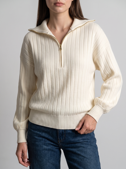 Woman wearing cream ribbed knit half-zip sweatshirt, front view with jeans