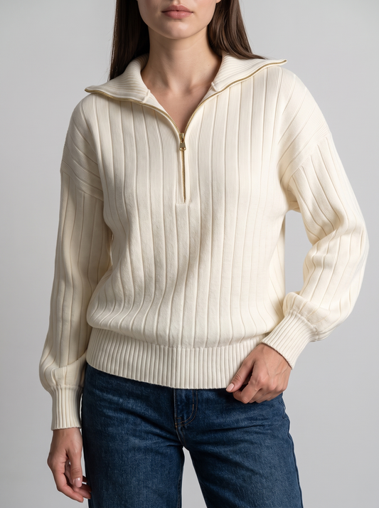 Woman wearing cream ribbed knit half-zip sweatshirt, front view with jeans
