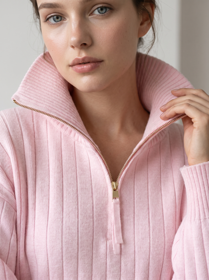 Woman wearing pink ribbed knit half-zip sweatshirt, close-up on collar and zipper