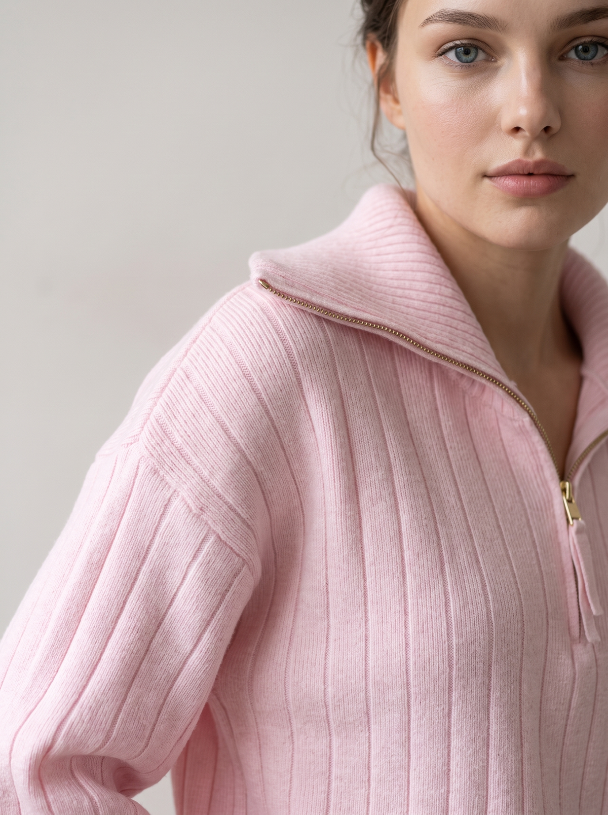 Close-up of pink ribbed knit sweatshirt funnel collar and shoulder