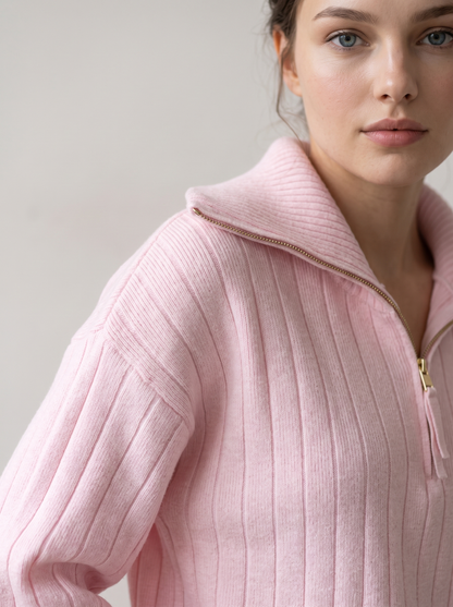 Close-up of pink ribbed knit sweatshirt funnel collar and shoulder