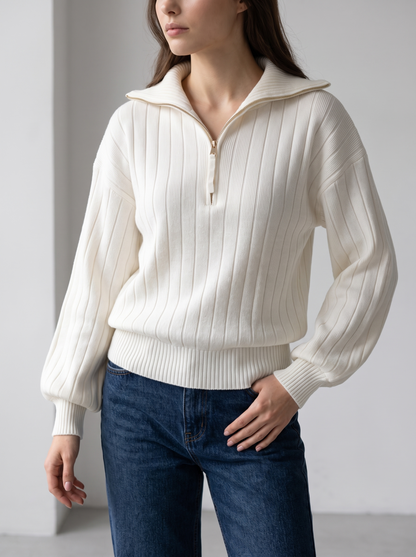 Woman wearing white ribbed knit half-zip sweatshirt, front view with jeans