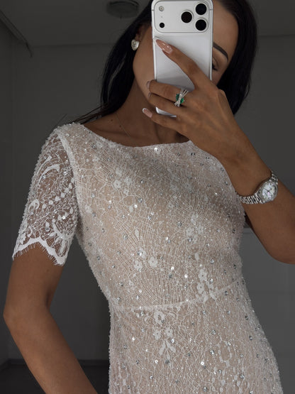 Close-up of beaded Chantilly lace bodice and short lace sleeve with crystals